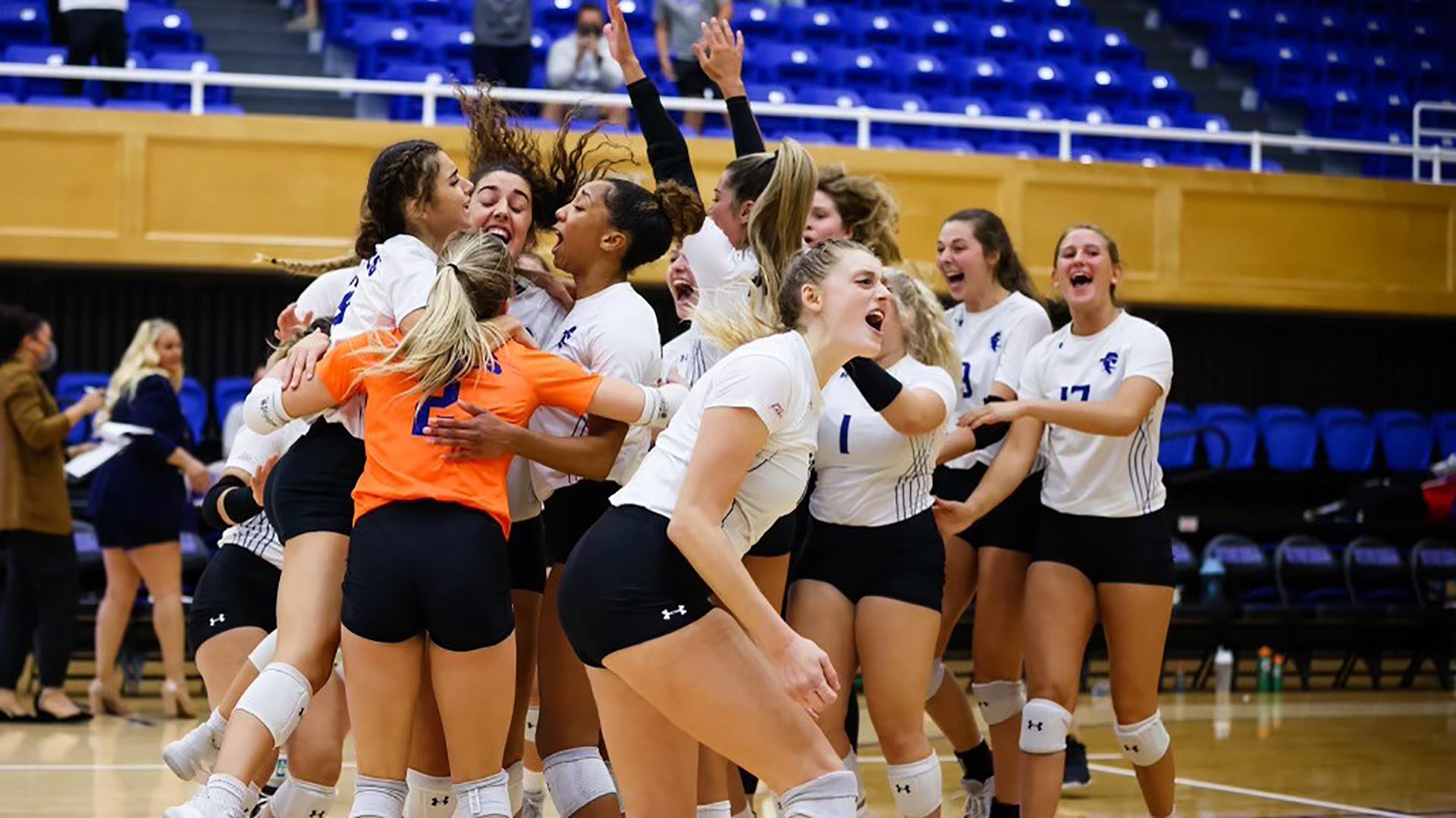 The Seton Hall women's volleyball team celebrates after winning a home match against the Providence Friars.