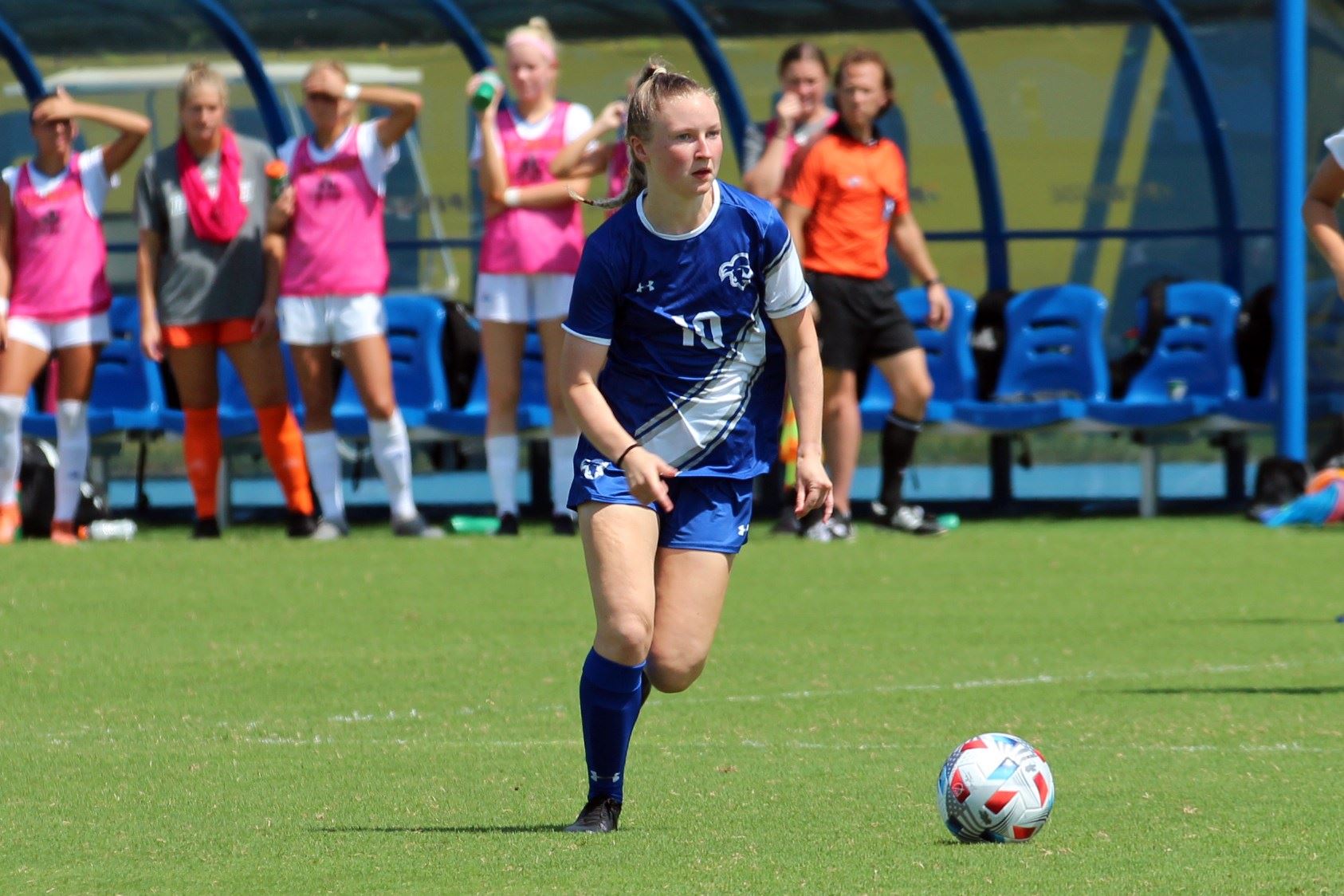 A Seton Hall women's soccer player dribbles the ball during a game on the road.