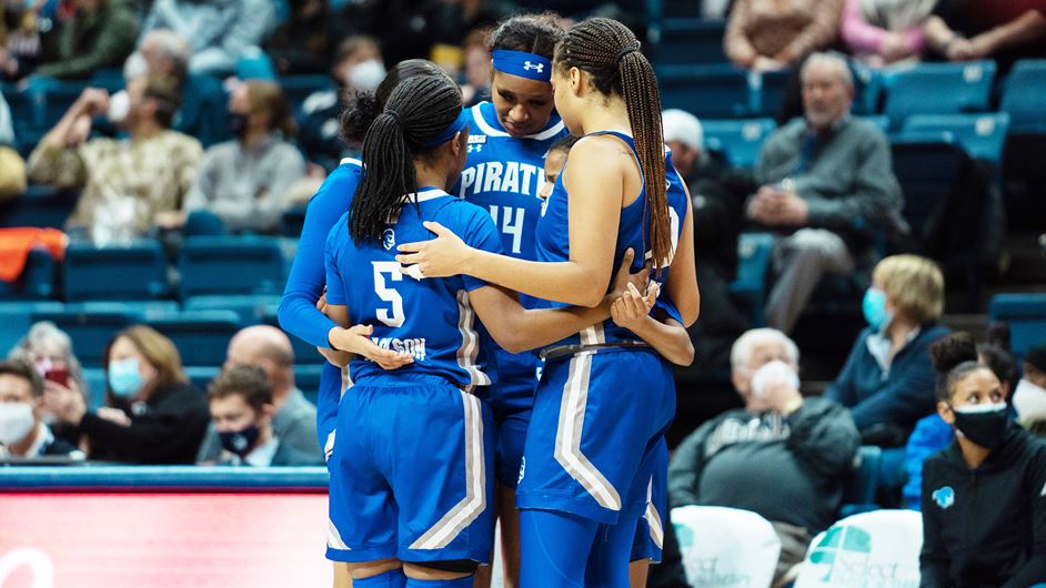 Members of the Seton Hall women's basketball team huddle during a game.