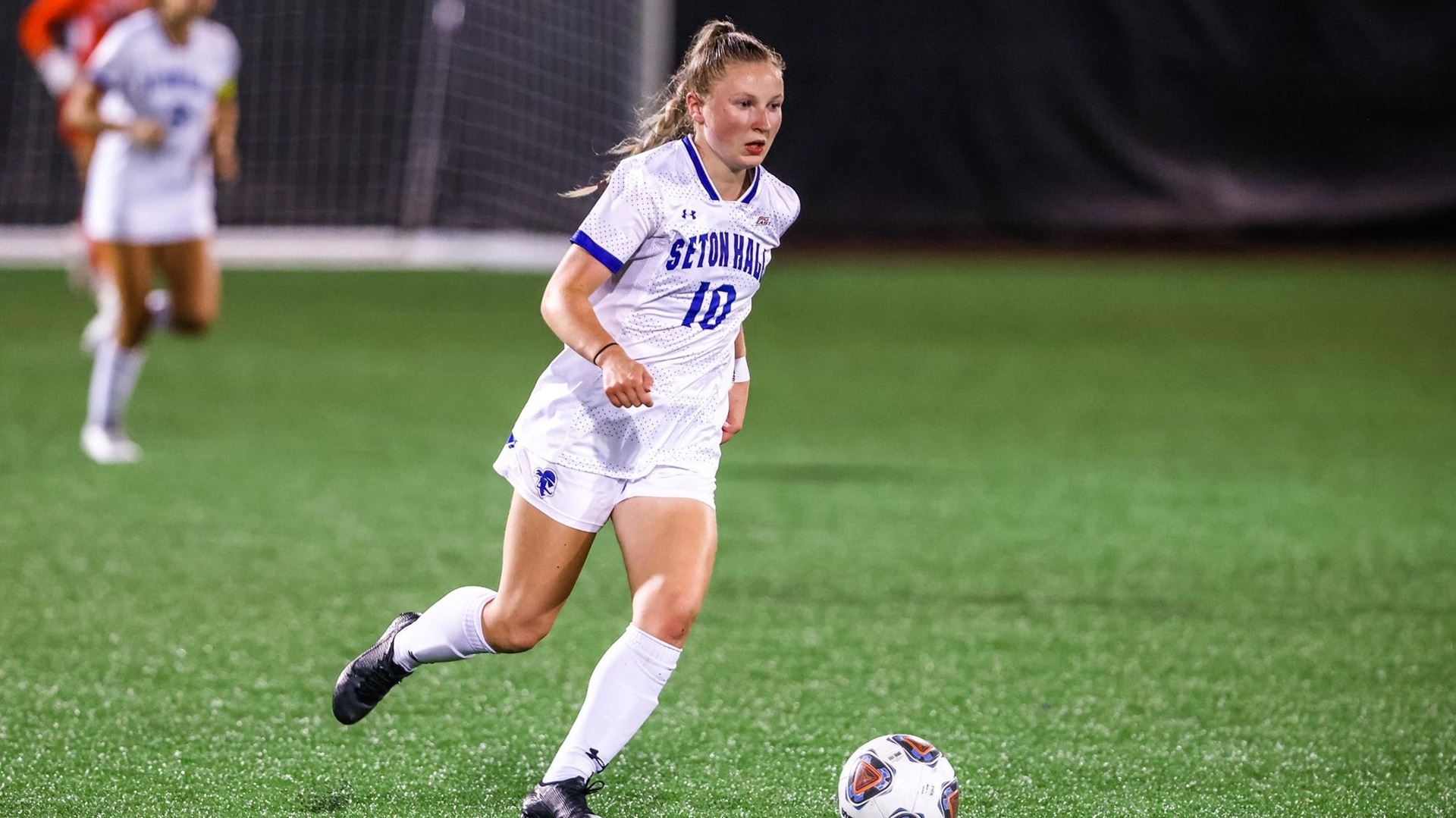 A Seton Hall women's soccer player dribbles the ball during a home game against the DePaul Blue Demons.