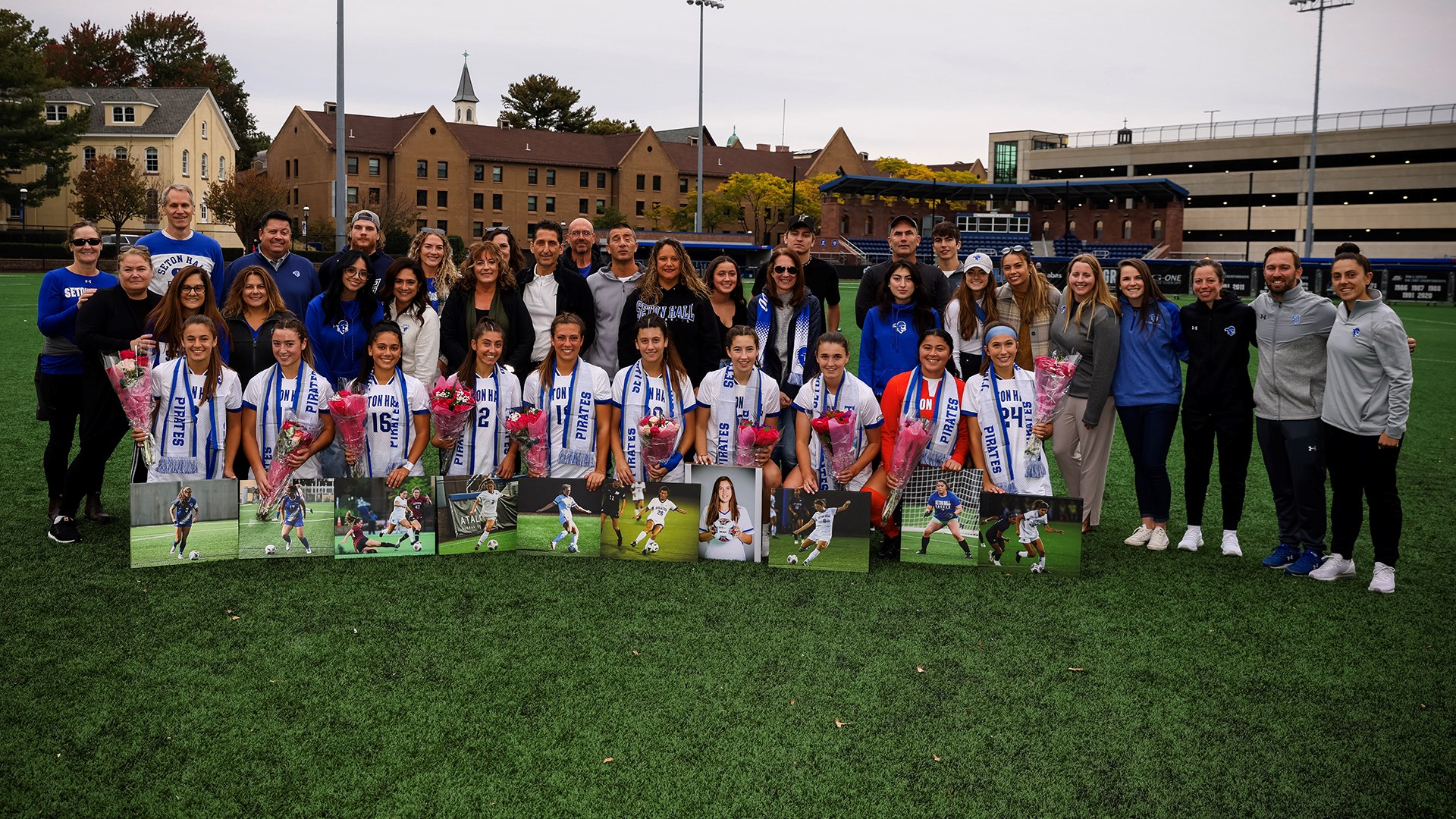 The Seton Hall women's soccer team poses for a photo with their parents during Senior Night.