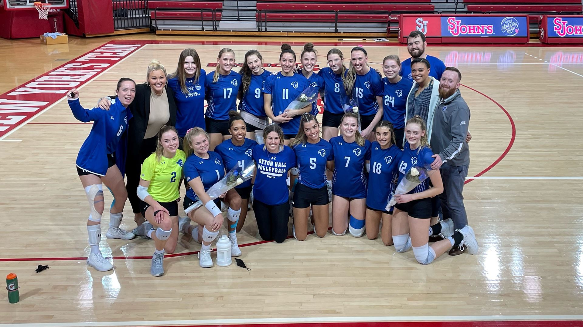 The Seton Hall women's volleyball team poses for a photo after a match.