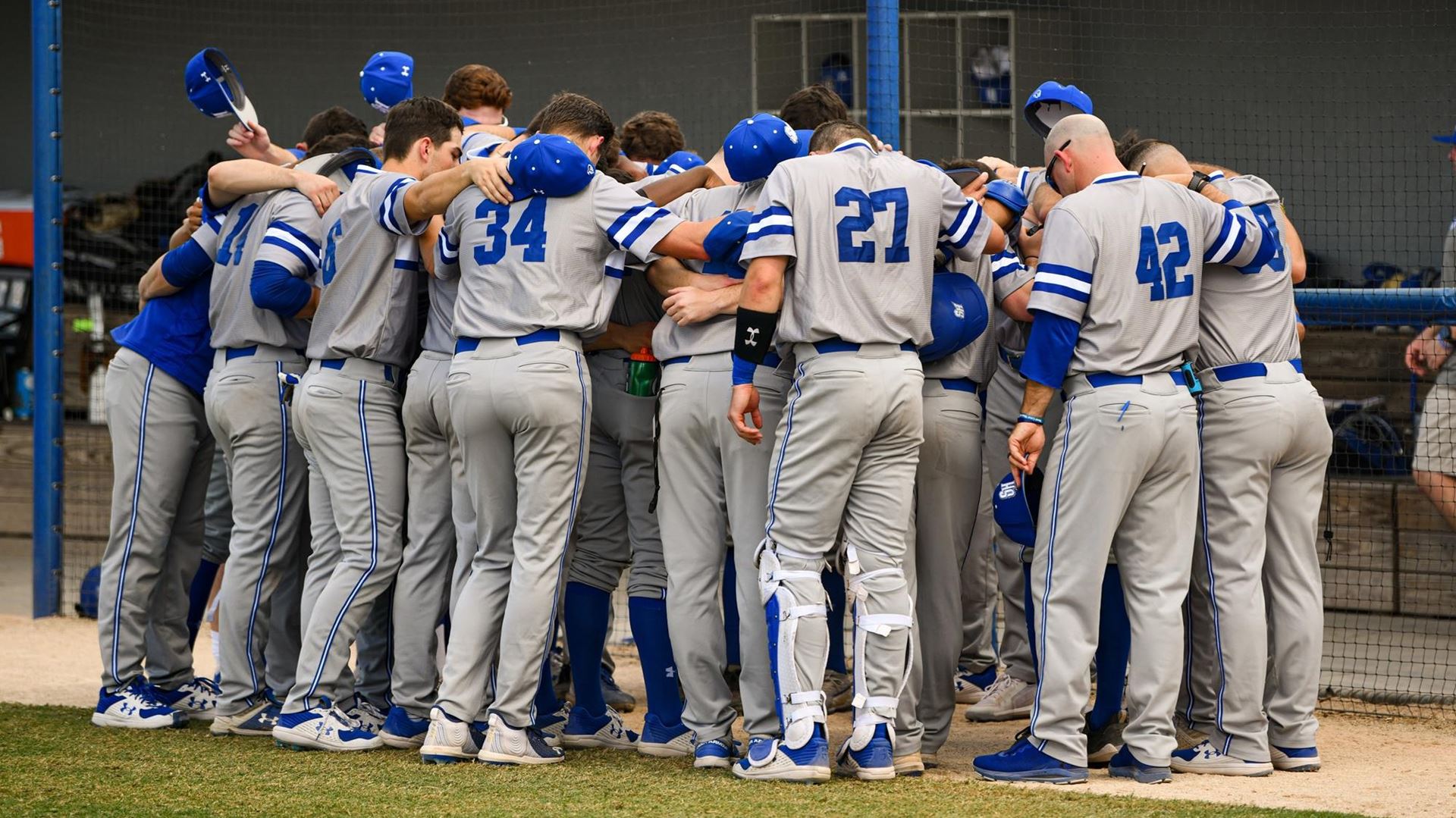 The Seton Hall baseball team huddles on the field during a game.