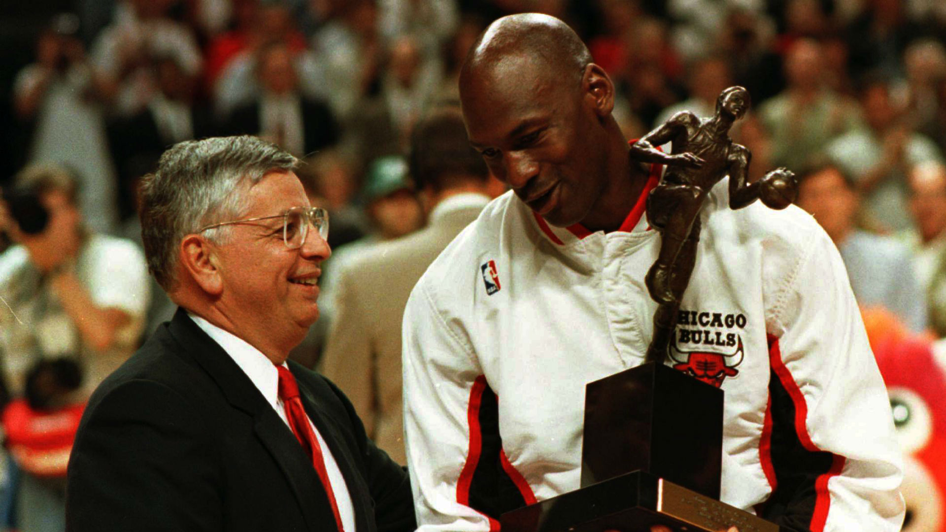 Commissioner David Stern hands Michael Jordan a trophy before a Chicago Bulls game.