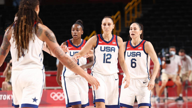 A group of Team USA women's basketball players celebrate after a win in the Tokyo Olympic Games.