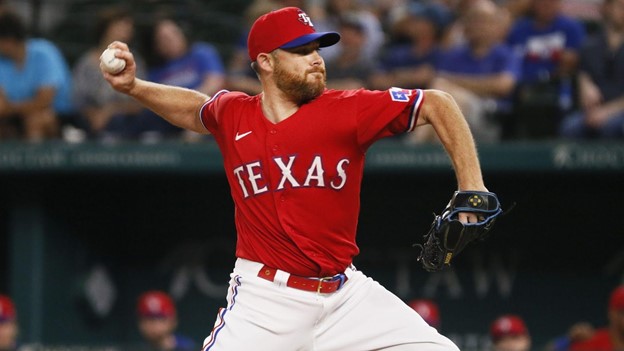 A Texas Ranger player delivers a pitch during an MLB game.