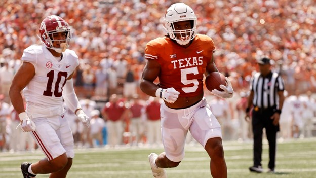 Texas player running away from a Bama defender. 