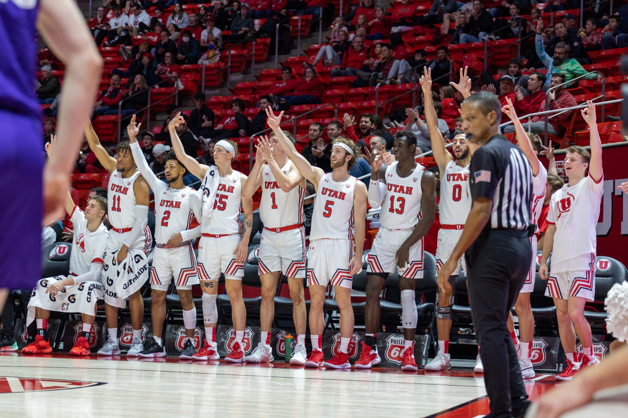 The Utah bench goes wild after a three pointer.