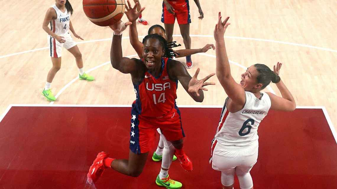 Team USA's Tina Charles drives in the paint to try and score a layup during an Olympics game.