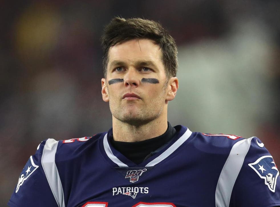 Former New England Patriots quarterback Tom Brady looks straight ahead during an NFL game.