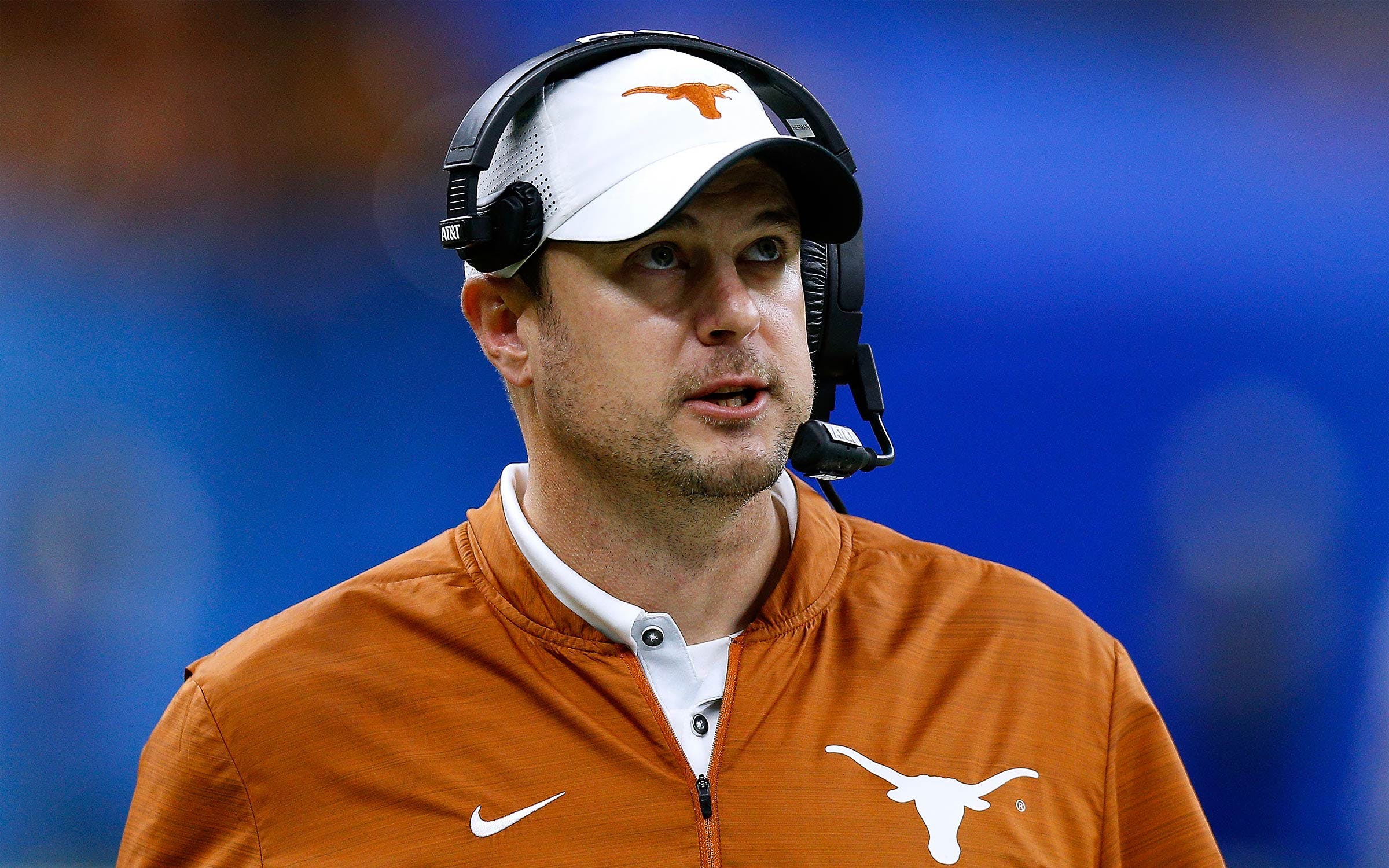 Texas head coach Tom Herman stands on the sideline during a college football game.