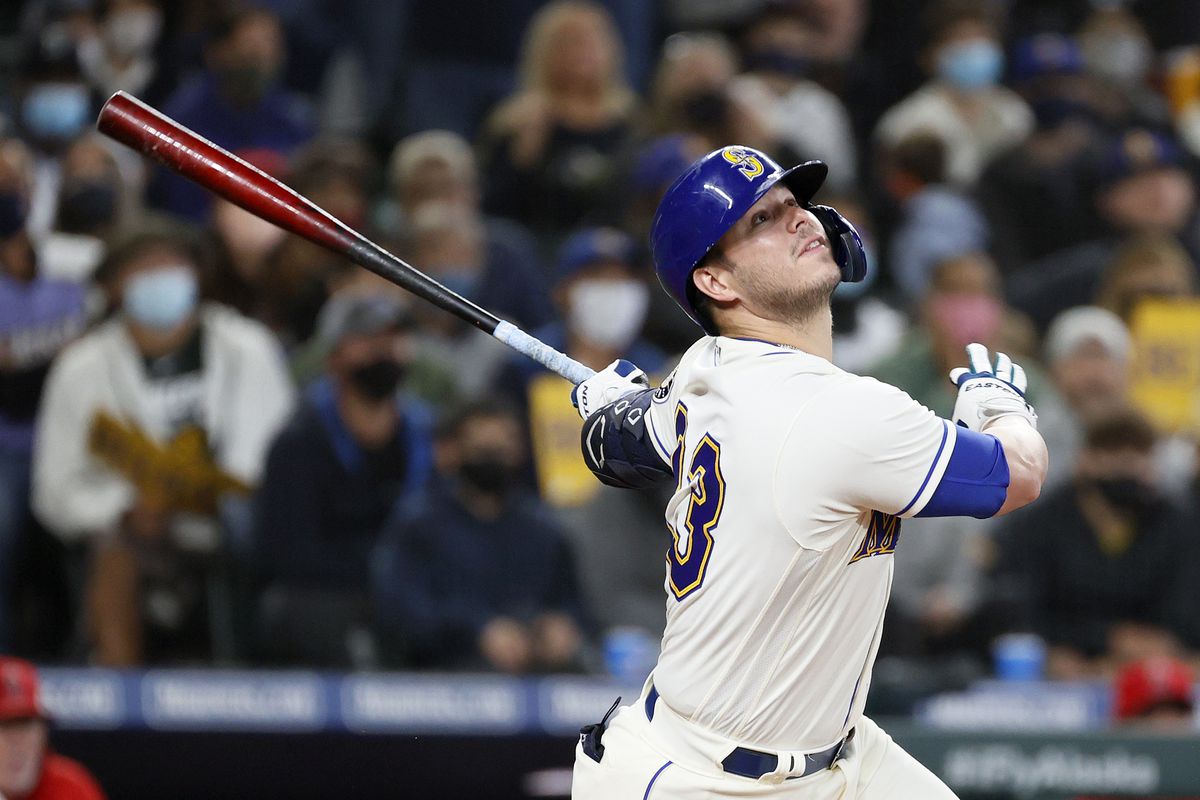 Ty France watches the baseball fly after he makes contact with a pitch.