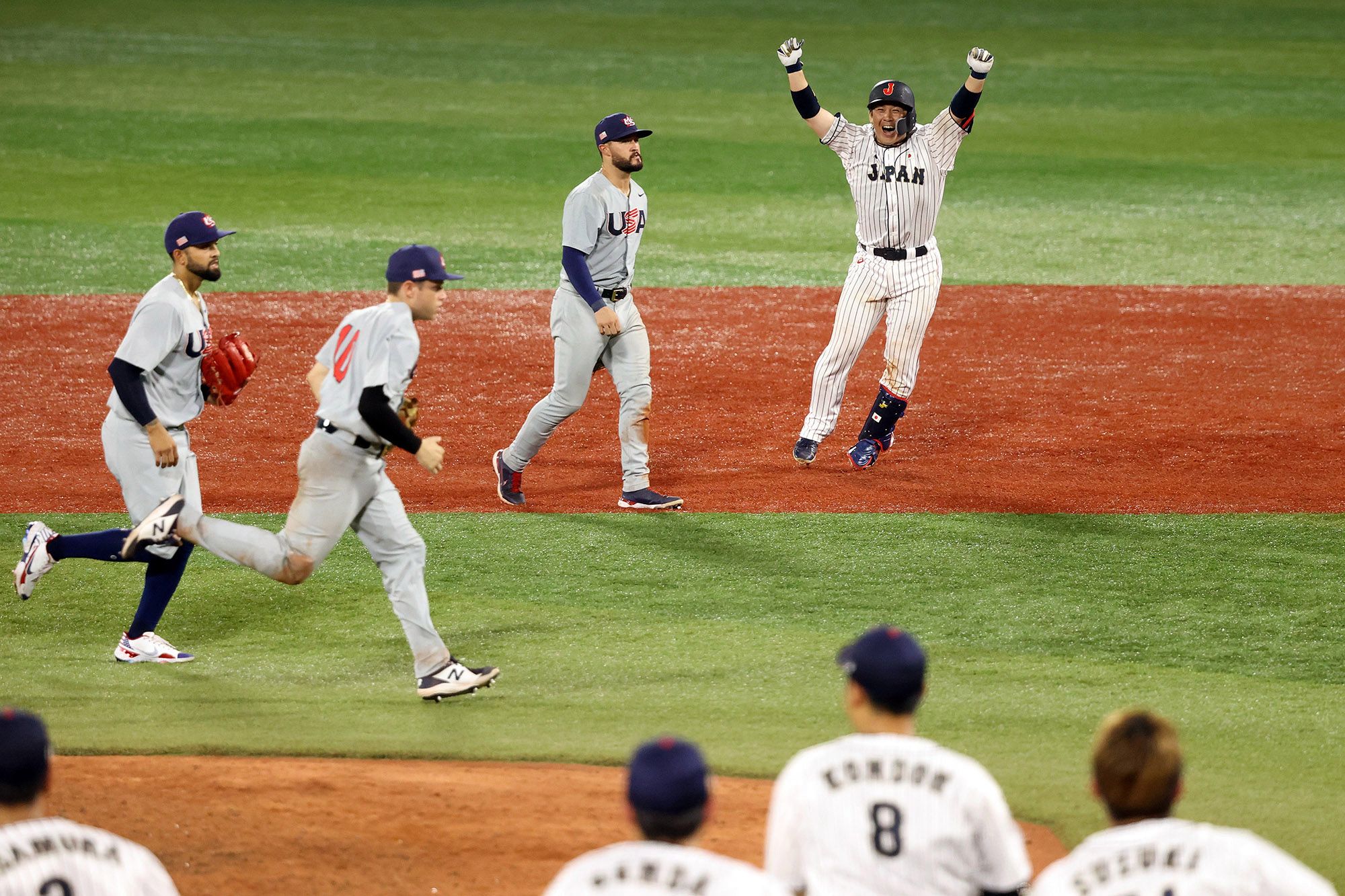 Team USA and Japan's baseball teams are on the field during an Olympics quarterfinals matchup.