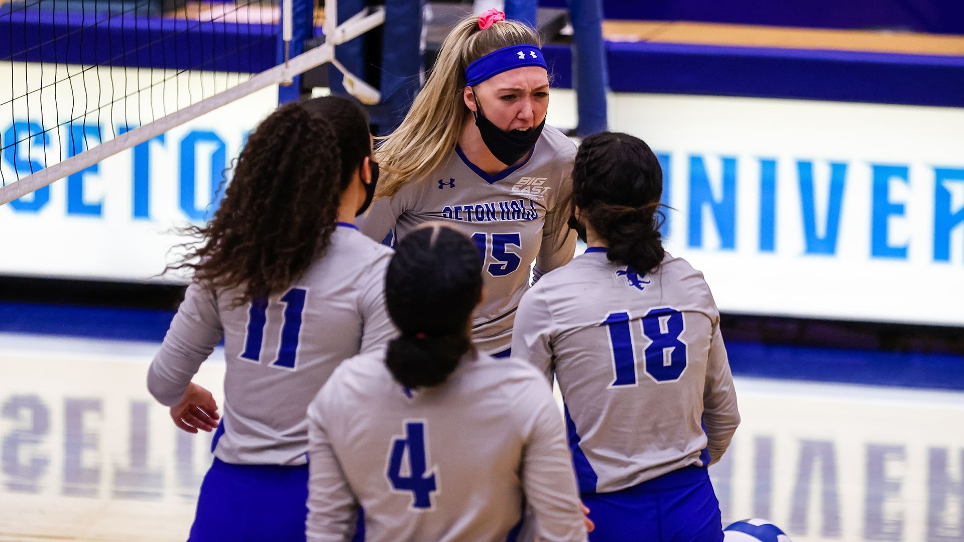 The Seton Hall women's volleyball team stand on the court during a game in Utah.