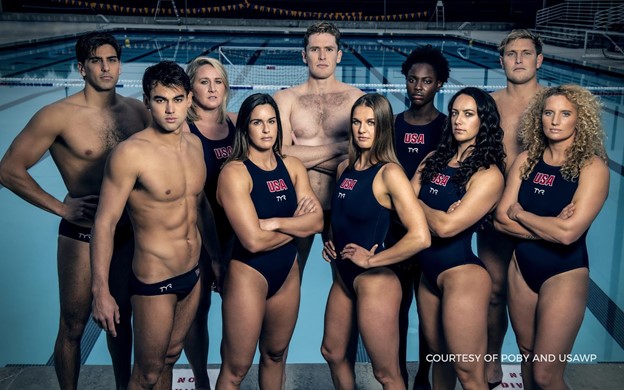 The USA Water Polo team stands around a pool to take a photo.