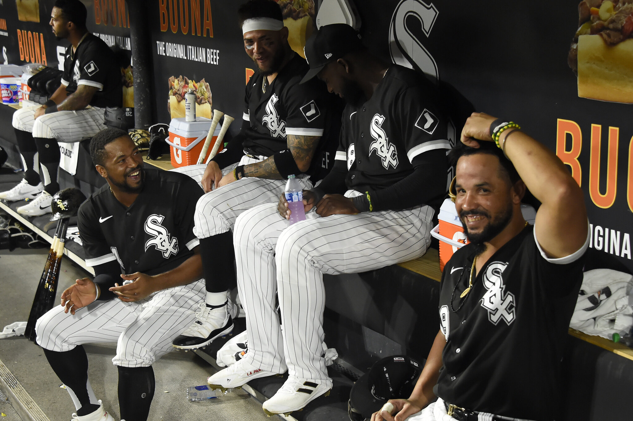 The Chicago White Sox sit in the dugout during a MLB game.