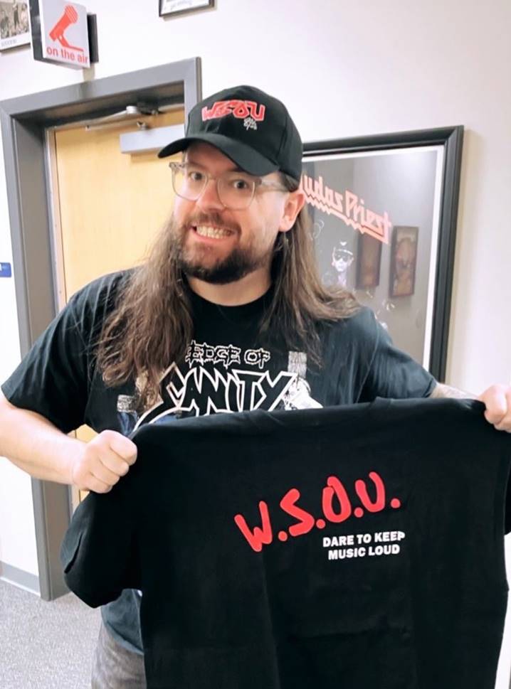 Trevor from the Black Dahlia Murder holding an SOU shirt