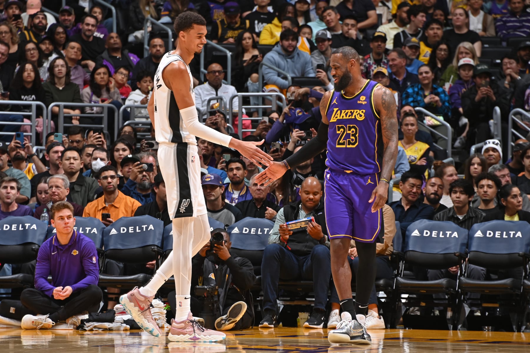 Victor Wembanyama (left) and LeBron James (right) share a moment during a 2024 game.