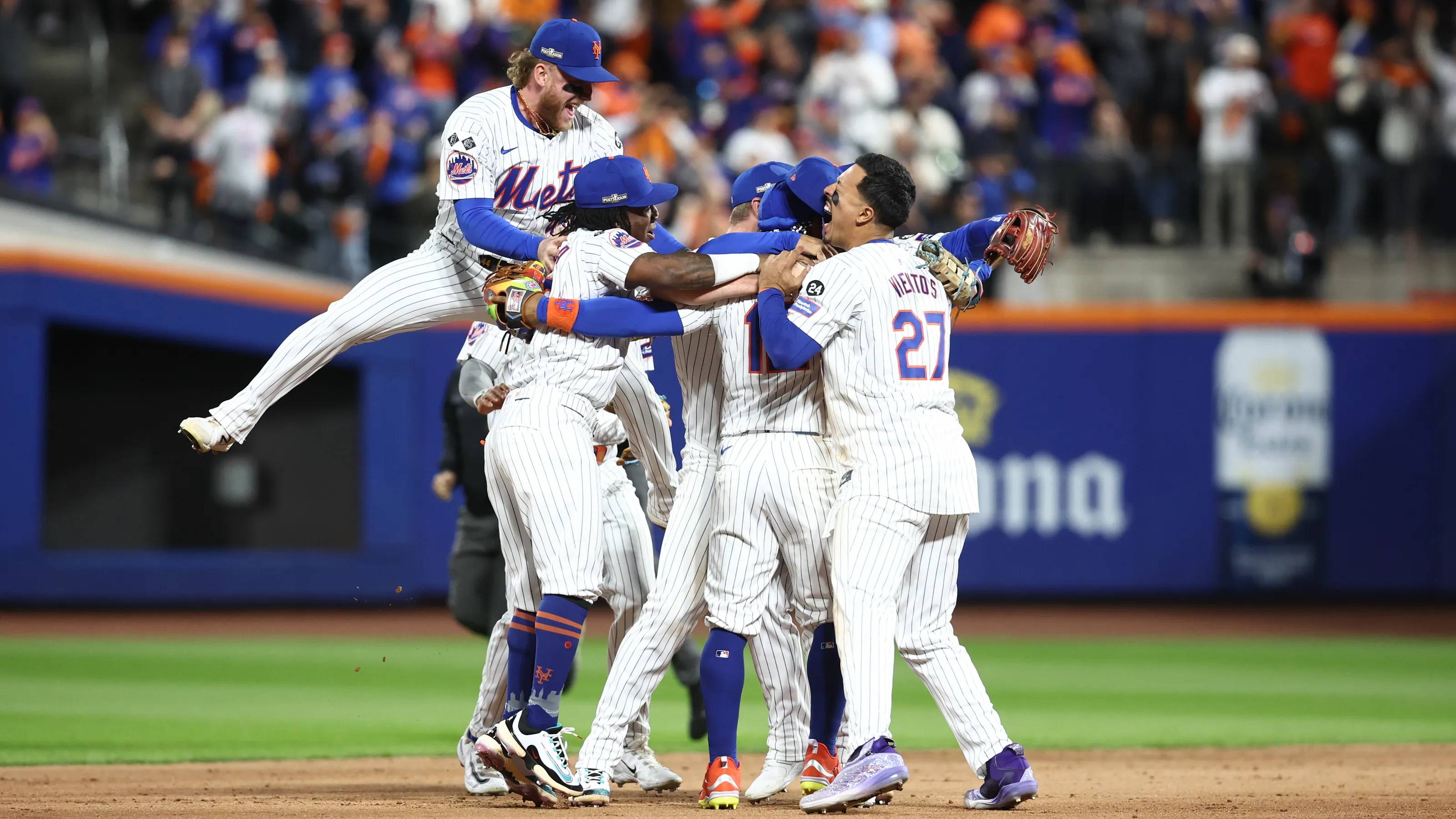 New York Mets players celebrate in the infield after defeating the Philadelphia Phillies in game four of the NLDS.