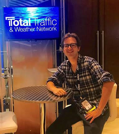 Dalton Allison sitting at the Total Traffic booth, where he currently works in NJ